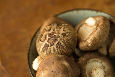 Shiitake mushrooms on a wooden table. Selective focus.の写真素材