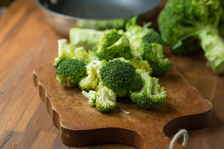 Healthy Green Organic Raw Broccoli Florets Ready for Cooking. Broccoli.Raw fresh broccoli on wooden table.の写真素材