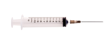 pills and plastic medical syringe on a white background.の写真素材