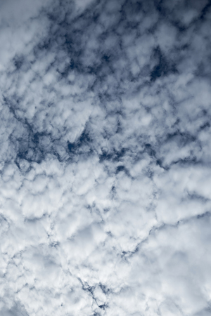 white fluffy clouds in the blue sky.