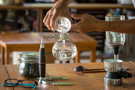 close up of siphon vacuum, coffee cup and siphon vacuum coffee maker at shop.の写真素材