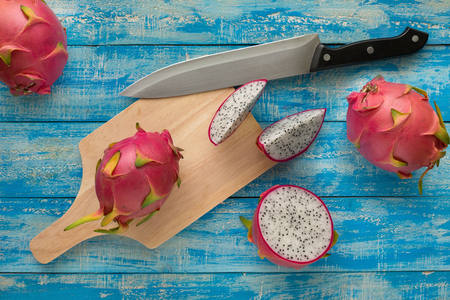 Tropical dragon fruit on blue wooden table background. Top view.の写真素材