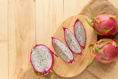 Tropical dragon fruit on wooden background. Top view.の写真素材