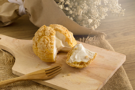 Choux Cream on plate. Cream puffs filled vanilla and milk custard.