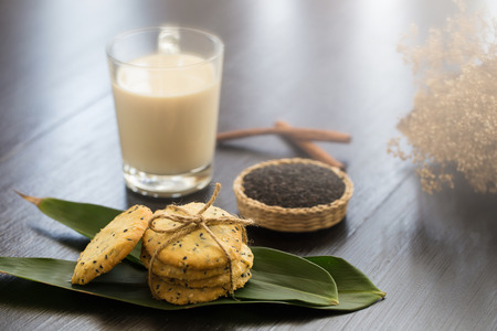Sesame Cookies, sesame and milk on black wooden background.の写真素材