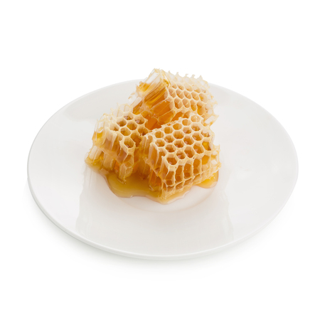 Sweet honeycomb On a white plate isolated on white background.の写真素材