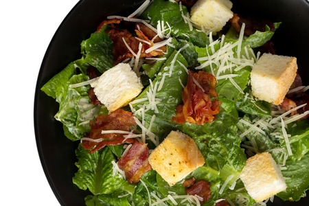 Caesar salad with crispy bacon fry and Fresh green cos lettuce isolated on white background.の写真素材