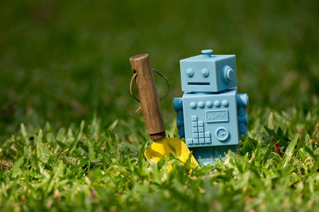 Blue Retro robot toys with garden tools in Natural green leaves background.