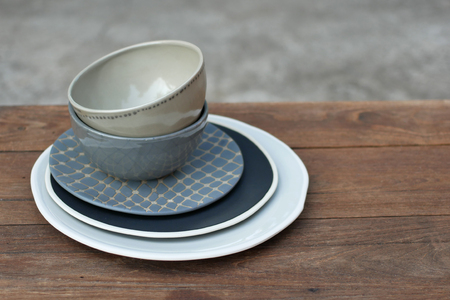 empty plates and bowls, kitchenware on wooden background.の写真素材