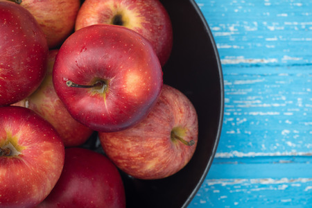 Red apples on a wooden table background.の写真素材