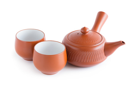 Japanese tea set. Ceramic teapot and a steaming cup Isolated on white background.の写真素材