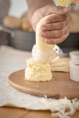 Mashed potatoes in a plate on a wooden table.の写真素材