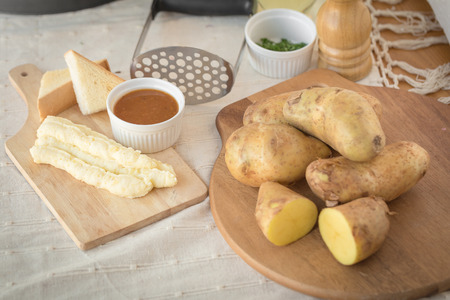 Mashed potatoes in a plate on a wooden table.の写真素材
