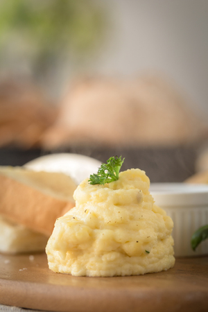 Mashed potatoes in a plate on a wooden table.の写真素材