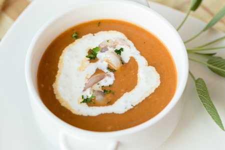 Vegetable cream soup with shrimps and croutons in white bowl close up.の写真素材