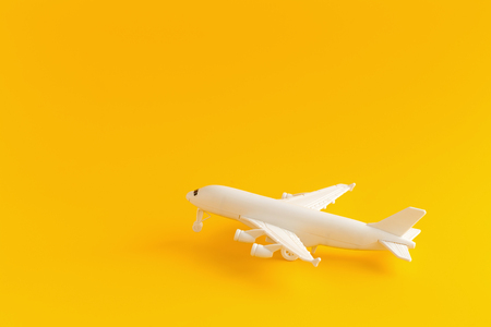Plastic toy airplane on a yellow Background.の写真素材