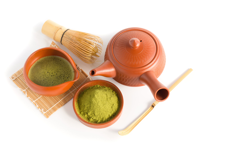 Matcha Green Tea and Japanese tea set. Ceramic teapot and a steaming cup Isolated on white background.の写真素材