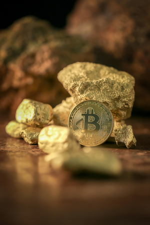 Gold bitcoin physical and Gold nugget grains. Concept mining cryptography.の写真素材