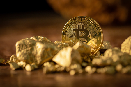Gold bitcoin physical and Gold nugget grains. Concept mining cryptography.の写真素材