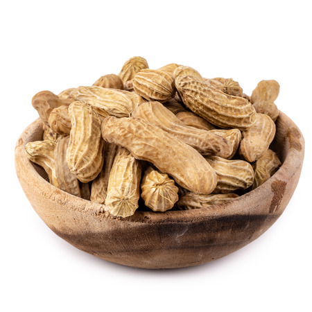 Dried peanuts in wooden bowl isolated on a white background.