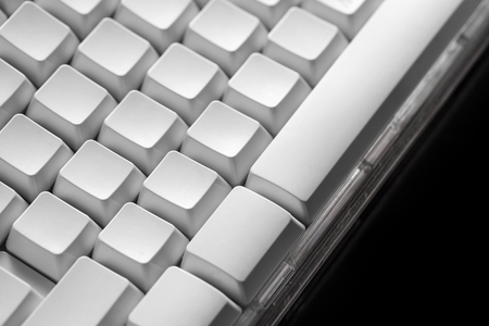 White computer keyboard. Technology and internet concept on black background.