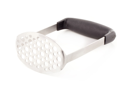 Metal potato masher isolated on a white background.