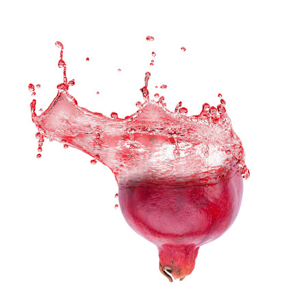 Ripe pomegranate fruit and pomegranate juice splashing isolated on white background.の写真素材