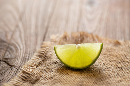 Fresh lime on the brown wooden table.の写真素材