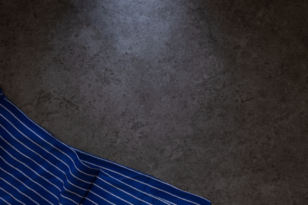 Blue napkin on dark wooden table. Top view with Copy space.の写真素材