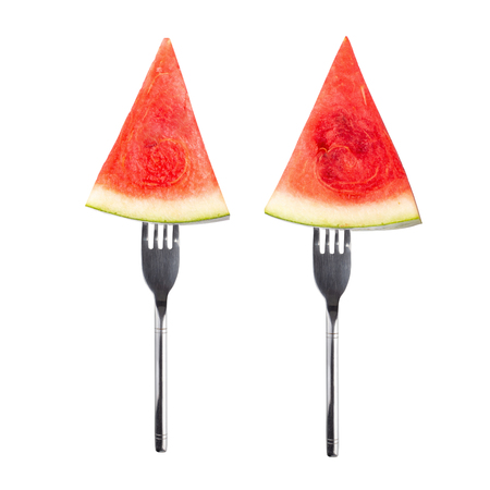 slice of watermelon on a Silver Fork isolated on white background.の写真素材