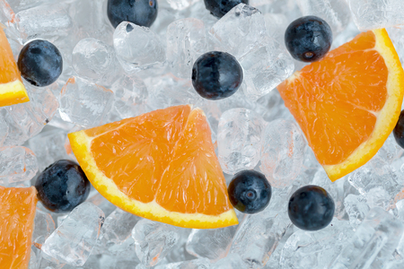 Orange Sliced and blueberries on ice tube background.の写真素材