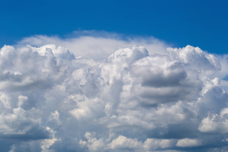 White fluffy clouds in the blue sky background.の写真素材