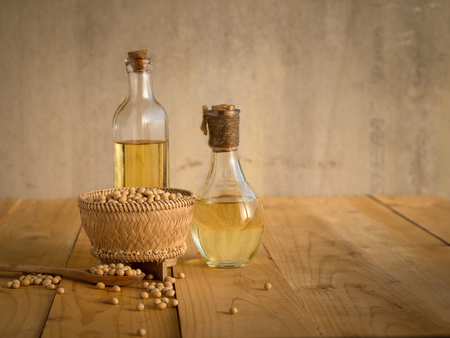 Soy bean and soy oil on a wooden table.の写真素材