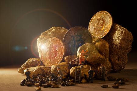 macro miner figures working on group of Bitcoin mining in deep golden cave.の写真素材