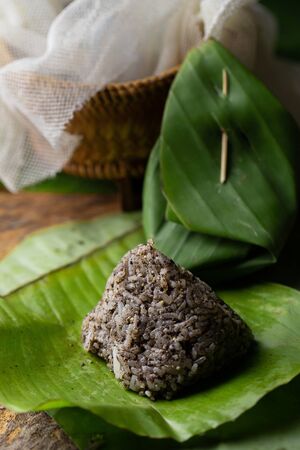 Rice chewy sesame rice with sesame or poppy (ivory bead, brown, gray) on banana leaves, pounded with salt and cooked rice new. Local Food of Northen Thailand.の写真素材