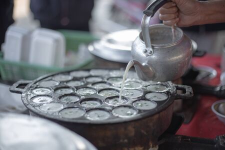 Thai sweetmeat (kanom kok)The making of Traditional Thai Sweet Coconut Rice Cake with variety of mixtures.の写真素材
