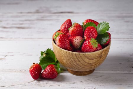 Fresh strawberries on a white wooden table.の写真素材