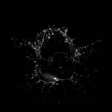 Water splashing isolated over a black backgroundの写真素材