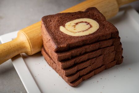 Chocolate bread stuffed with jam rolls topped with chocolate sauce.