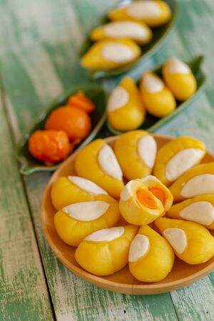Aalaw or Alua, Thai traditional candy sweet dessert is a Thai dessert that has durian eggs and salted on a wooden tray.の写真素材