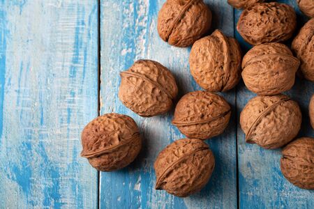 Walnuts kernels on a blue rustic wooden table.