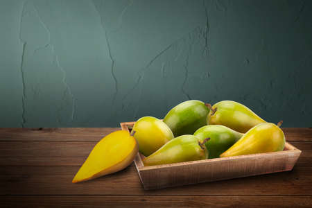 Egg fruit, Canistel, Yellow Sapote, Pouteria lucuma in wooden tray.の写真素材
