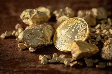 Gold bitcoin physical Bitcoin-Cryptocurrency and Gold nugget grains. Business concept.