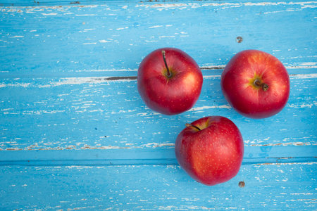 Red apples on a wooden table background.の写真素材