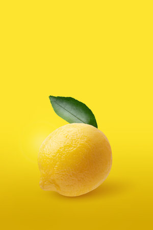 Creative layout made from lemon fruit and leaves isolated on yellow backgroundの写真素材