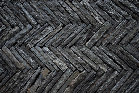 The surface of the stone wall is arranged in an orderly manner. Showing textures and patterns. Suitable to be used as a background image and graphic design.の写真素材