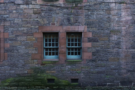 Vintage Window Embedded in Stone Wall of an Ancient Houseの写真素材