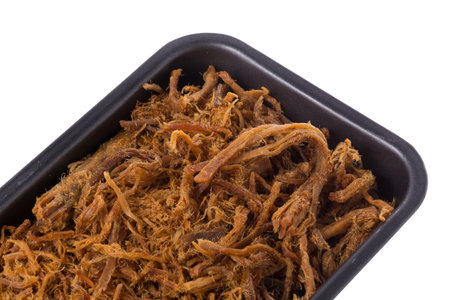 Dried shredded pork in pan isolated on a white background.