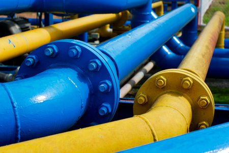 Handling Pressure Systems with Blue and Yellow Gas Pipes and Valvesの写真素材