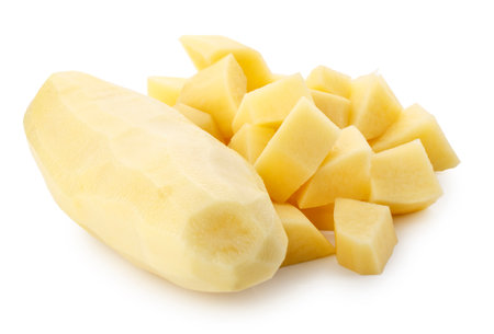 Whole raw potatoes and Raw potatoes, cut into pieces isolated on a white backgroundの写真素材